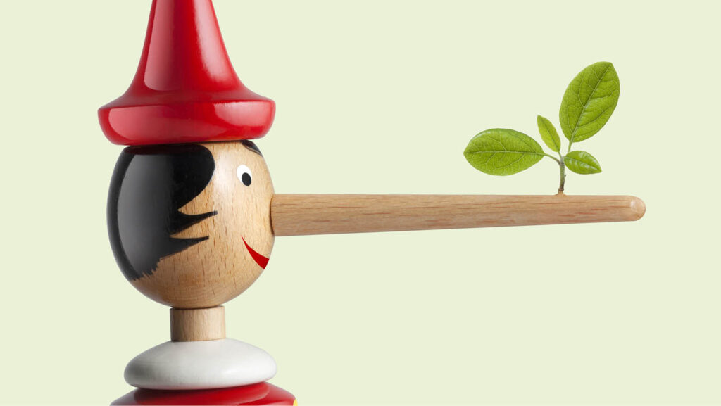 A wooden Pinocchio doll with a long, growing nose that has a small green plant sprouting from its tip, set against a light green background. The image symbolizes greenwashing, where misleading claims (Pinocchio's nose growing) are made about environmental friendliness (the green plant).